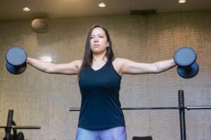 Woman lifting weights for muscle strengthening