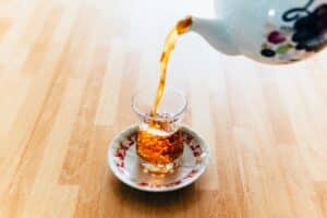 A picture showing herbal tea being poured into a glass as part of intermittent fasting routine