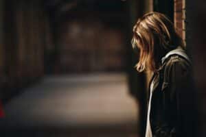 Picture of girl with head looking down showing signs of depression